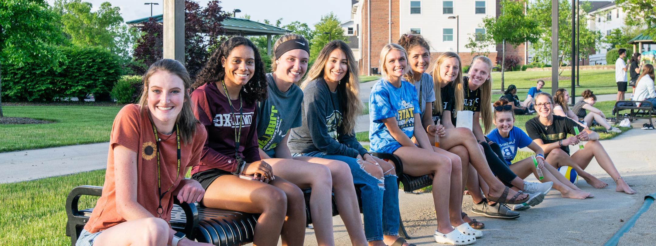 PFW students watching sand volleyball on the Student Housing campus.